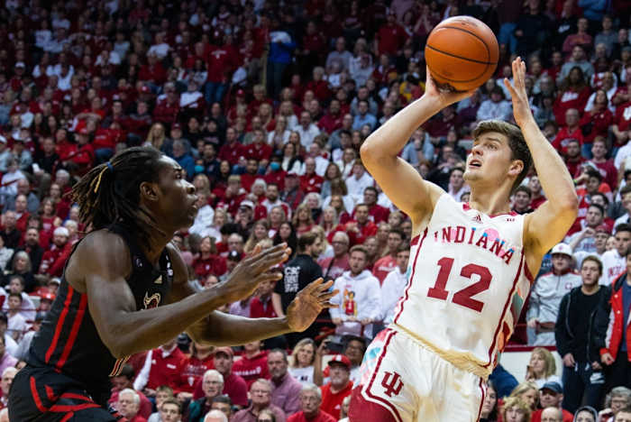 Miller Kopp (12) shoots the ball while Rutgers Scarlet Knights center Clifford Omoruyi (11) defends.